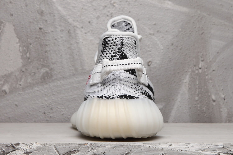 Rear view of the sneaker showing the padded heel area, patterned upper, and rounded sole.