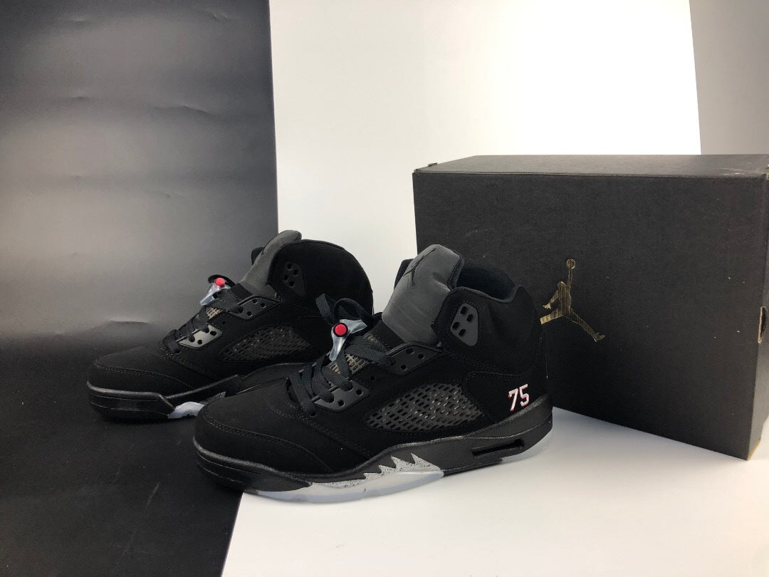 Pair of black Jordan 5 high-top sneakers displayed beside a black box.