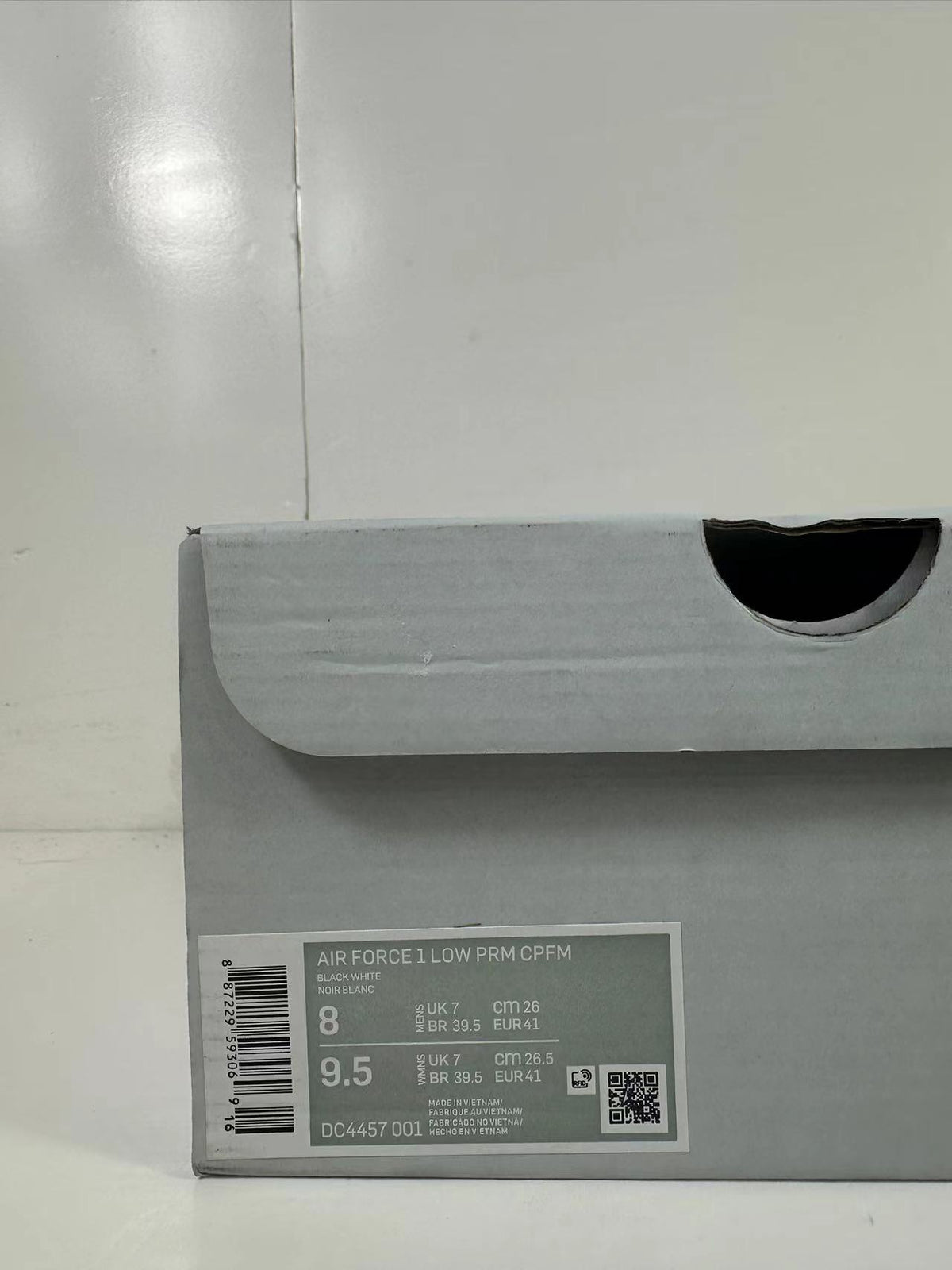 Close-up of the shoe box label showing AIR FORCE 1 LOW PRM CPFM, black and white color text, EU 41, and style code DC4457 001.