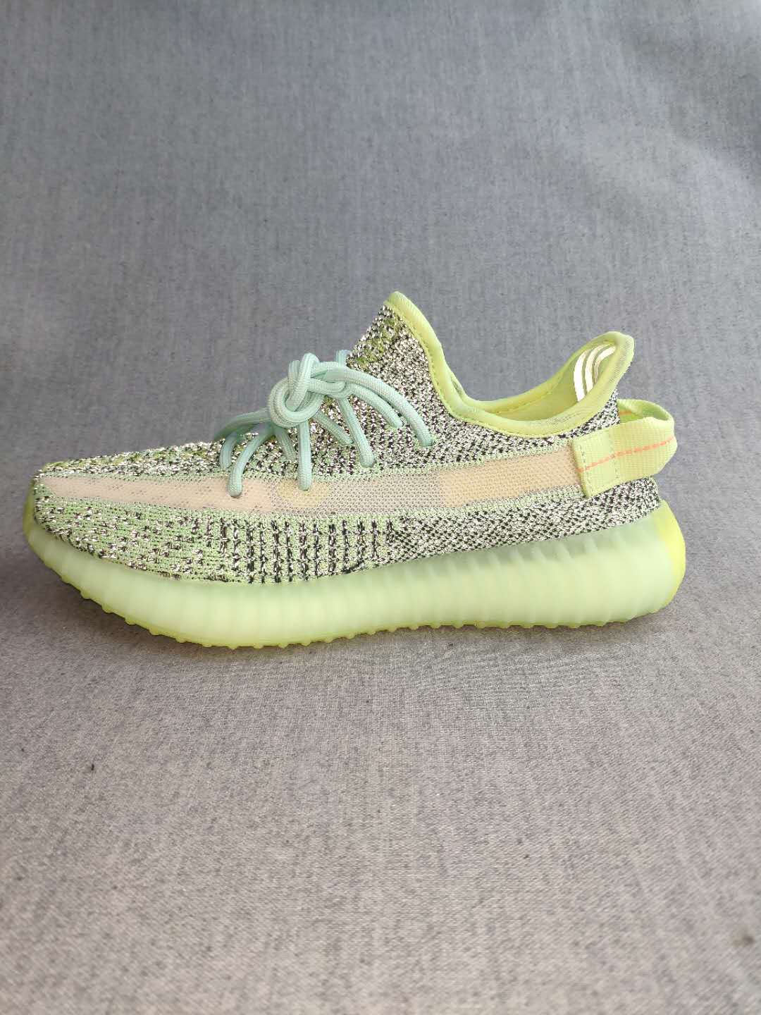 Profile view highlighting the side stripe, patterned upper, and ridged sole.