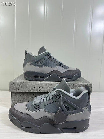 Two grey Air Jordan 4 Retro SE sneakers shown from angled side views on a textured display box.