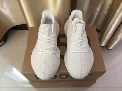 Top-down view of the white lace-up sneakers showing the knitted uppers and toe boxes.