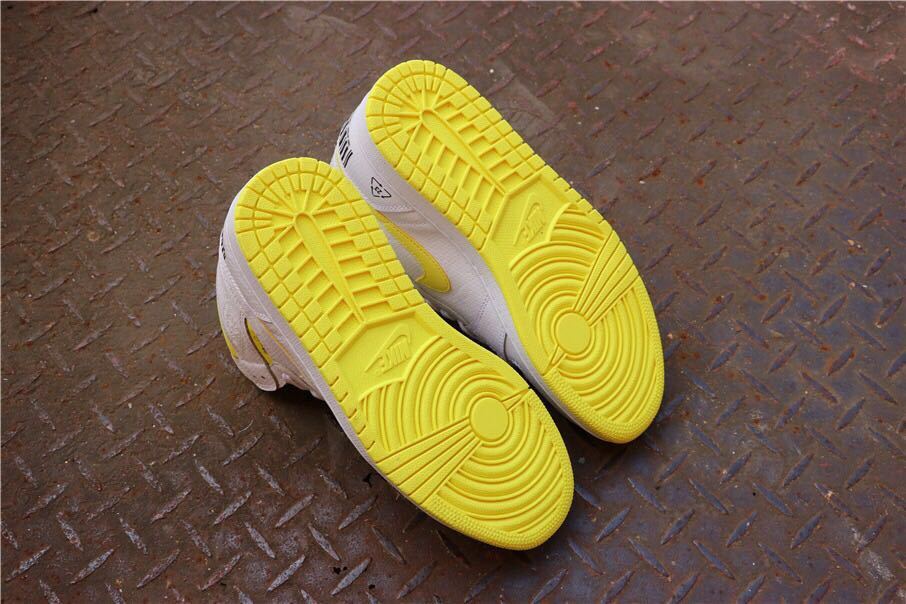 Bottom view showing the yellow rubber outsoles and circular traction patterns.