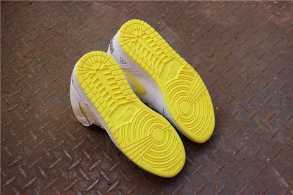 Bottom view showing the yellow rubber outsoles and circular traction patterns.