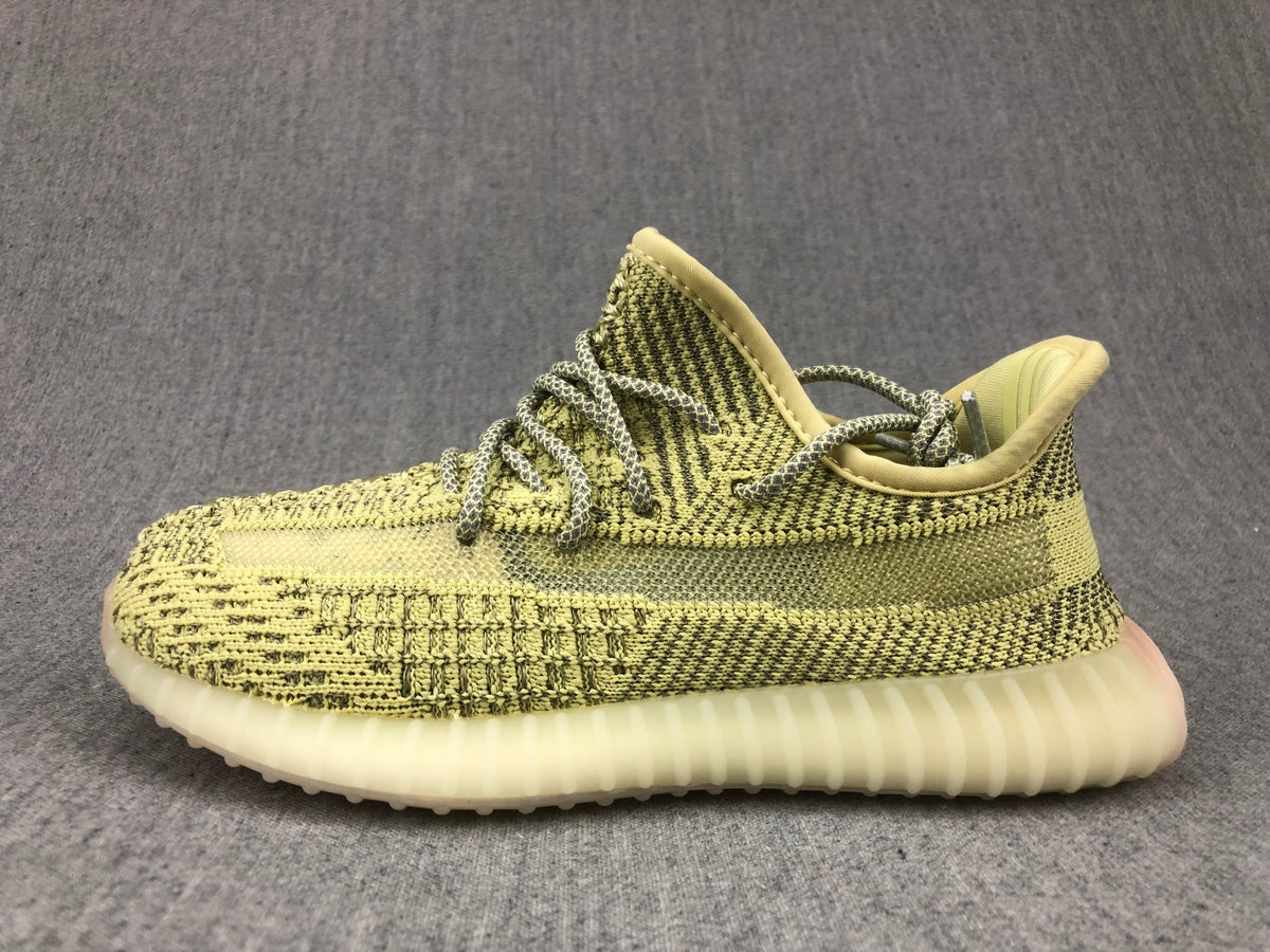 Side profile of the olive-yellow and black lace-up sneaker.