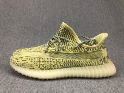Side profile of the olive-yellow and black lace-up sneaker.