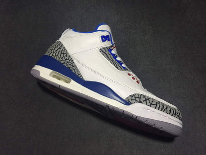 Angled side view highlighting the white upper, blue midsole accents, elephant-print overlays, and visible air window.