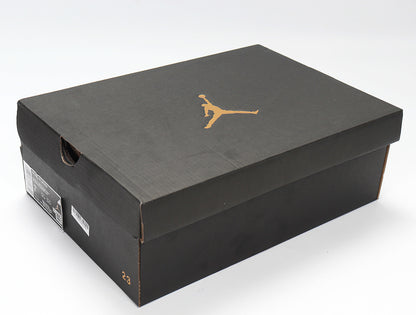 Black Jordan shoebox with a gold Jumpman logo and visible side labels.