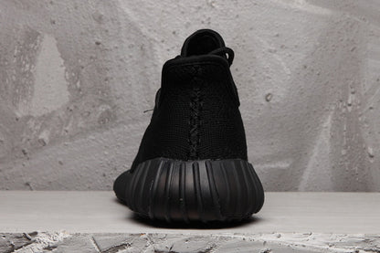 Rear view showing the black heel construction and segmented ribbed outsole.
