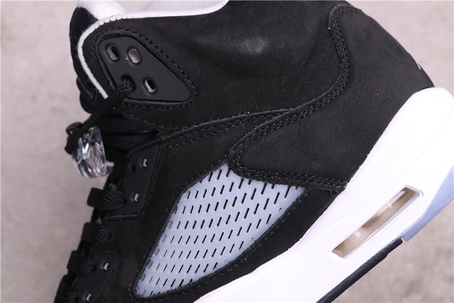 Close-up of the black upper, stitched overlays, translucent side panel, and white midsole cushioning window.