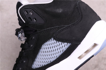 Close-up of the black upper, stitched overlays, translucent side panel, and white midsole cushioning window.