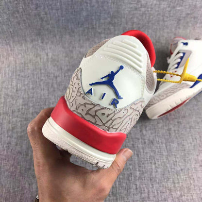 Rear view showing the blue Jordan heel logo, patterned grey heel panel, red heel accent, and white outsole.