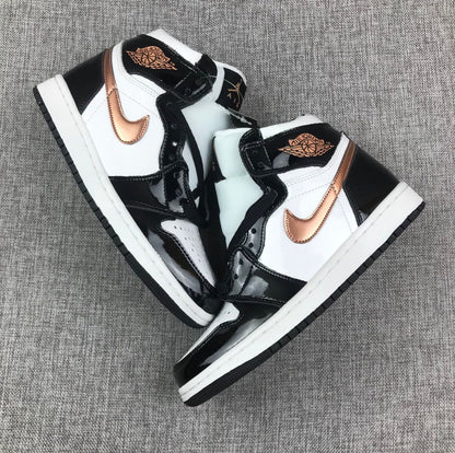 Pair of black, white and metallic-gold high-top sneakers arranged diagonally.