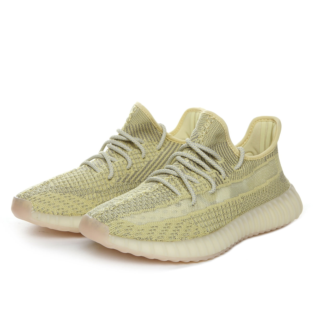 Three-quarter view of olive green Yeezy 350 V2 sneakers showing the patterned upper, laces, and ribbed outsole.