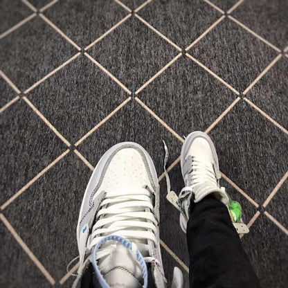 Top-down view of the perforated toe box, white laces and grey eyelet overlays.