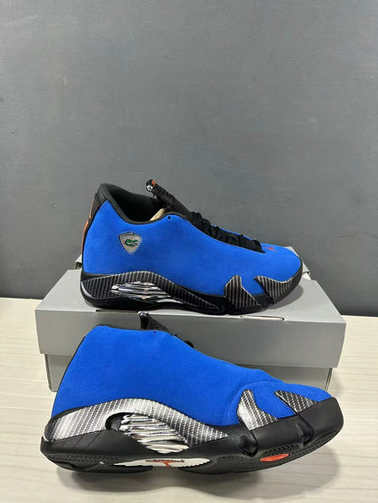 Pair of blue and black Jordan Air Jordan 14 Retro sneakers shown from side and outsole angles with silver midsole accents.