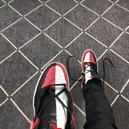 Top view of the black, red, and white color-blocked toe and tongue areas.