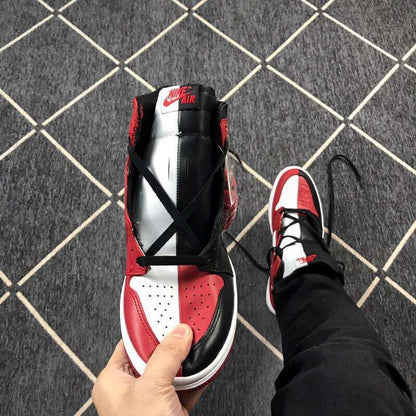 Top-down view highlighting the black laces, split-color tongue, perforated toe box, and red and white panels.