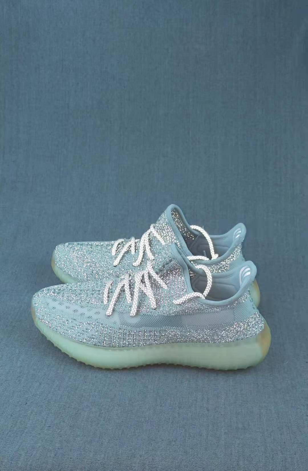 Pair of shimmering pale icy low-top sneakers shown from an angled side view.