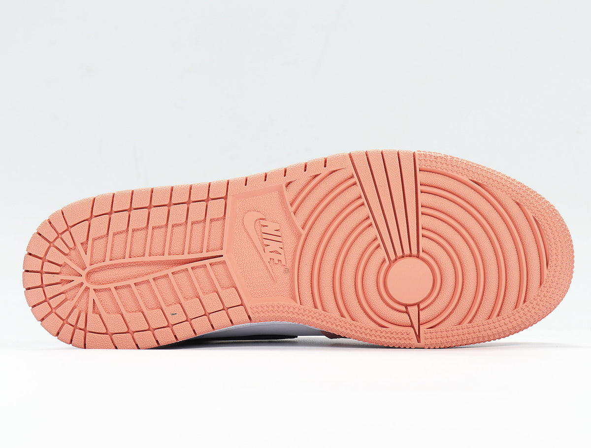 Underside view showing the pink rubber outsole with circular traction and patterned tread.