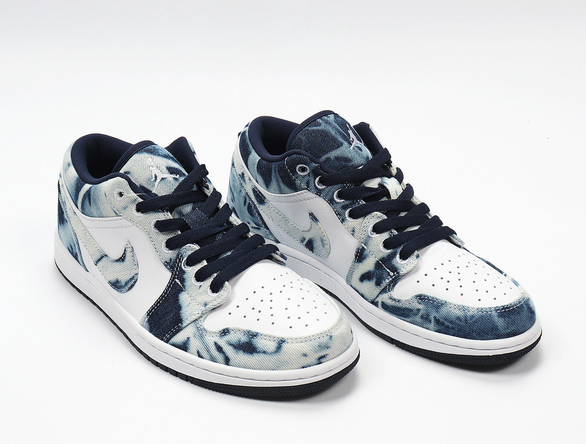 Three-quarter view of the paired low-top sneakers with washed denim-look panels and white side sections.