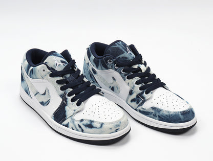 Three-quarter view of the paired low-top sneakers with washed denim-look panels and white side sections.