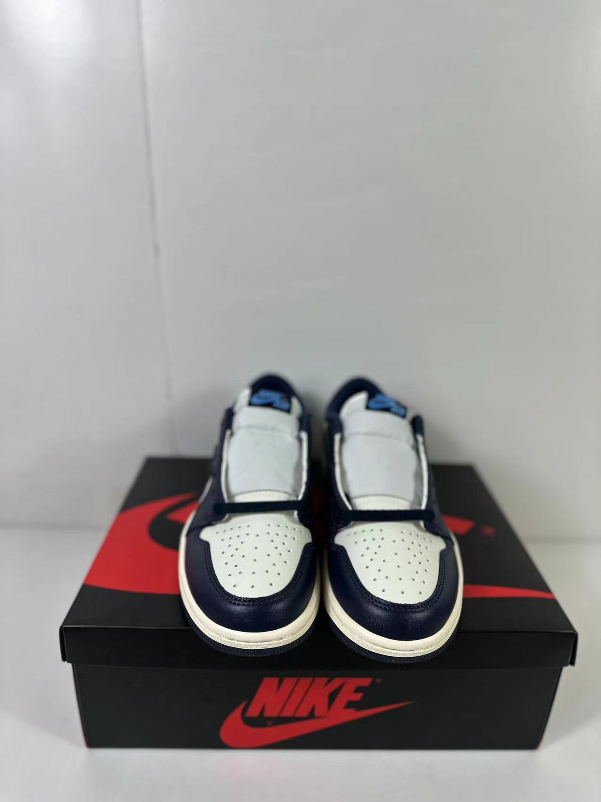 Front view of the pair showing perforated white toe boxes and dark contrasting overlays.