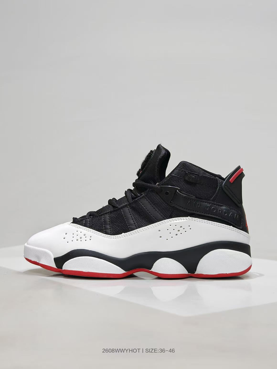 Side profile showing layered black upper panels, white side panels, and a red outsole edge.