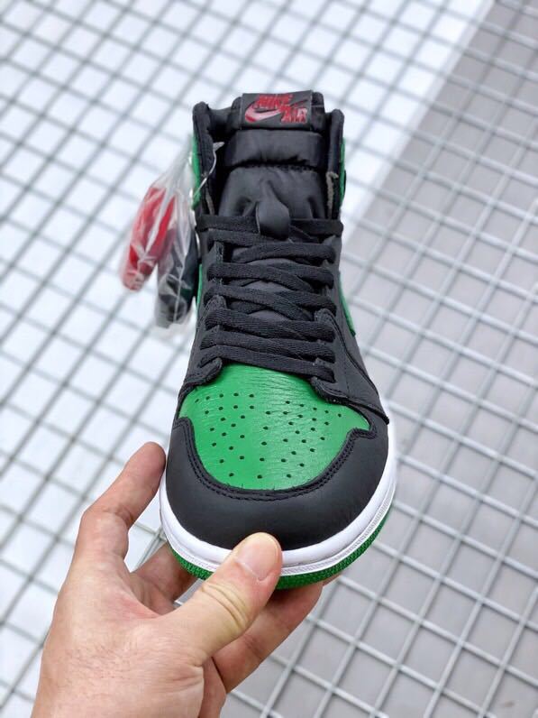 Front view showing the green perforated toe box, black overlays, and padded tongue.