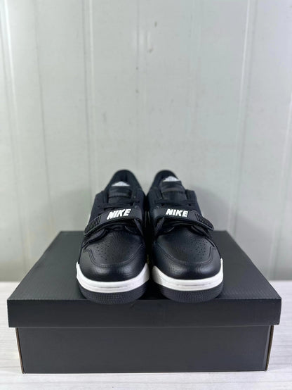 Front view of the sneakers showing perforated black toe boxes, black straps, and white midsoles.