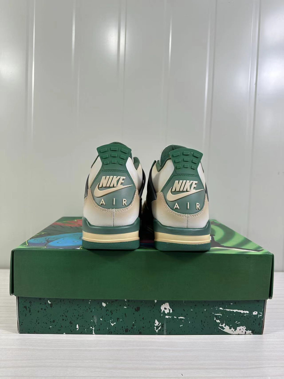 Rear view showing green heel sections, Nike branding and AIR lettering.