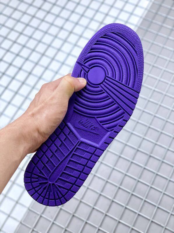 Underside view showing the fully purple rubber outsole with circular traction patterns.