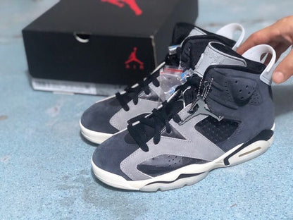 Three-quarter view of the black and grey high-top sneakers with white midsoles and light grey overlays.