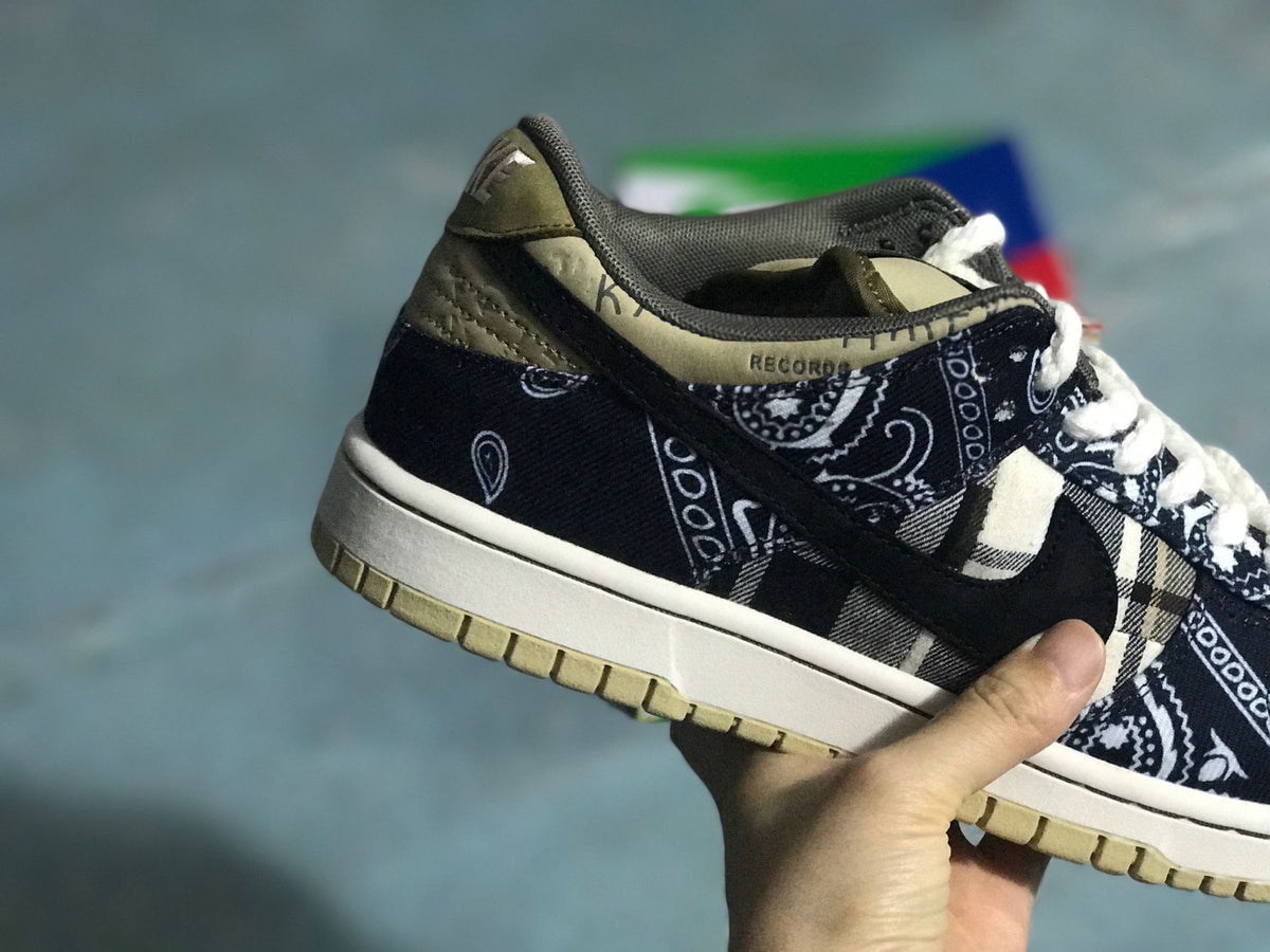 Rear-side close-up showing the patterned heel panel, dark Swoosh, light midsole, and beige outsole.