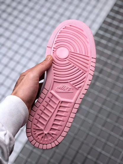 Underside view showing the pink outsole with circular and linear traction grooves.