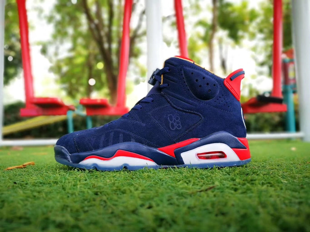 Side view highlighting the perforated collar, navy upper, red accents, and cushioned heel area.