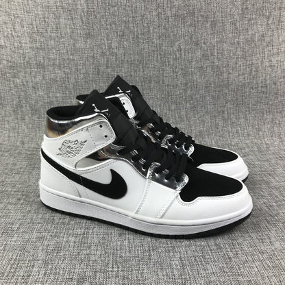Three-quarter front view of the pair with black toe boxes, white overlays, and metallic silver eyelet panels.