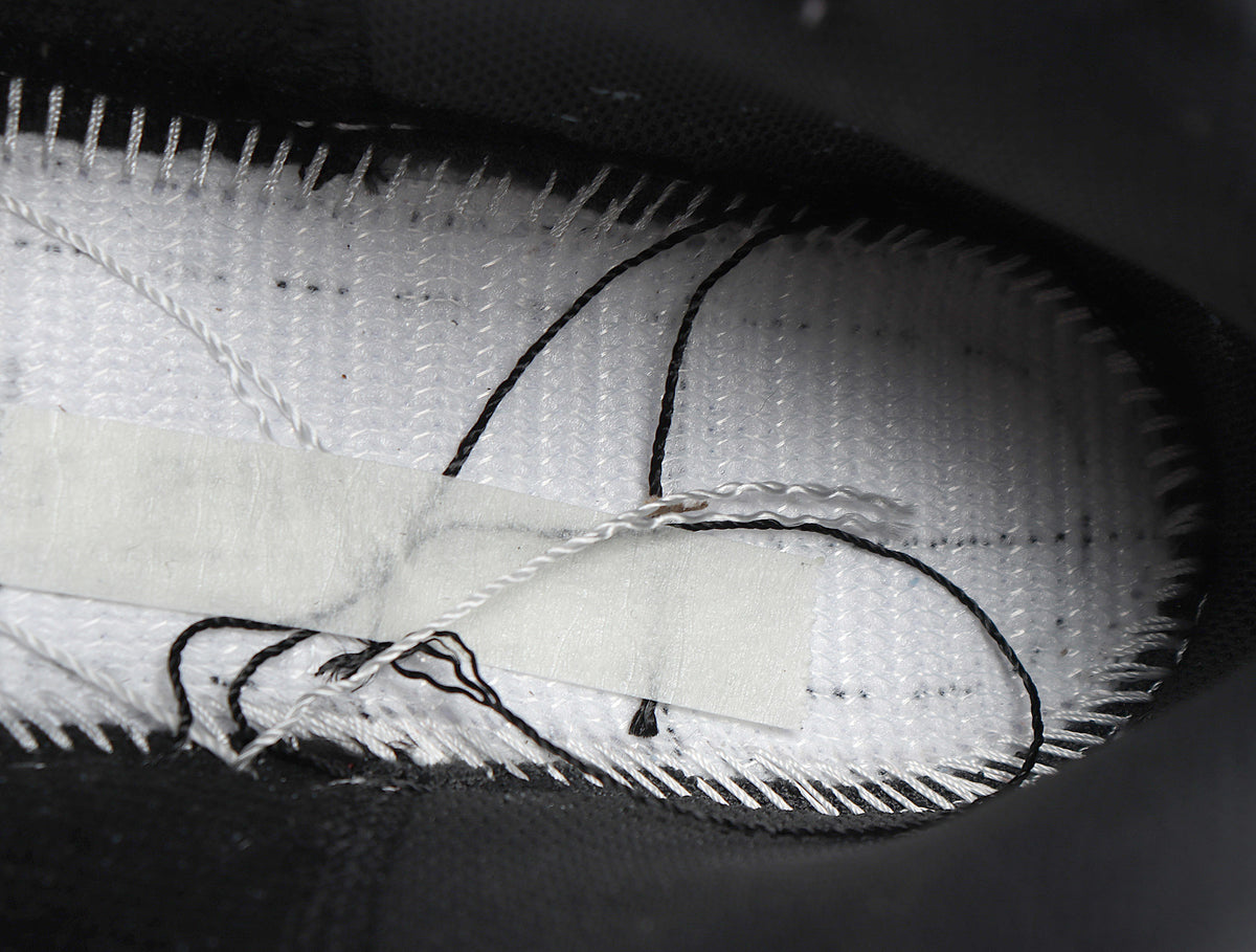 Close-up of the sneaker interior showing the textile lining, stitching, and insole construction.