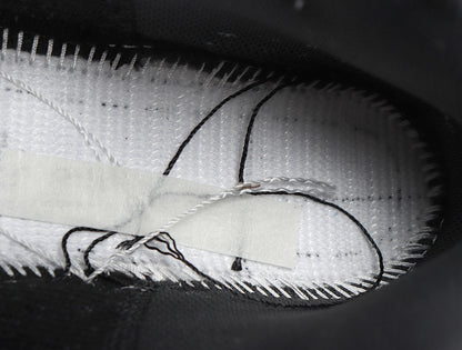 Close-up of the sneaker interior showing the textile lining, stitching, and insole construction.