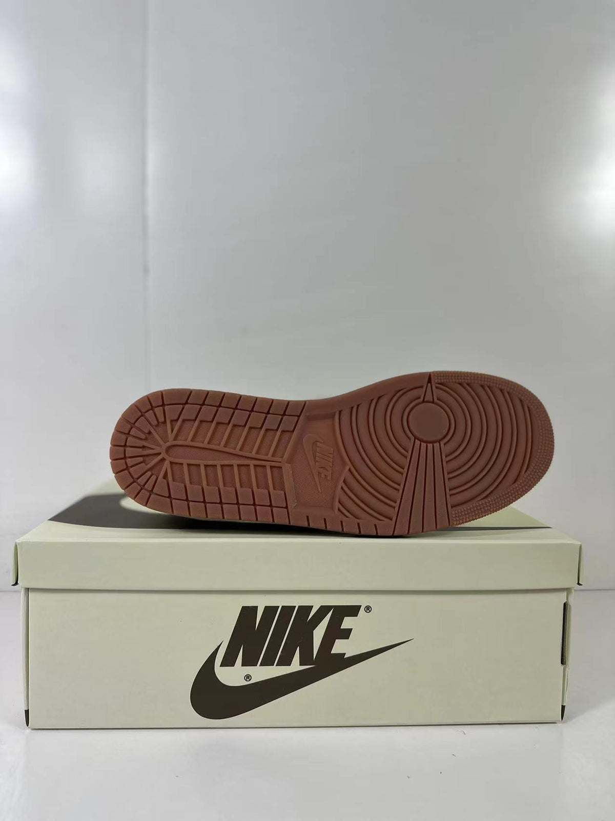 Underside view showing the gum-colored outsole and circular traction pattern.