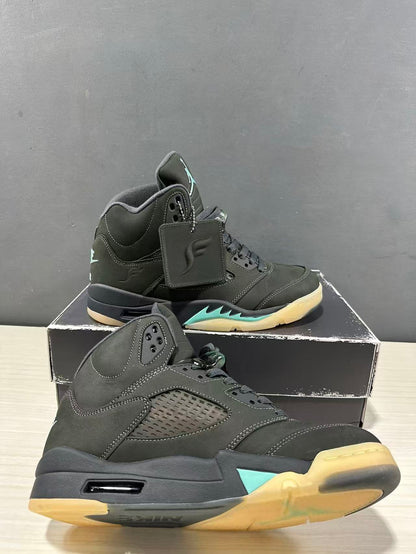 Angled view of the Jordan Air Jordan 5 sneakers showing perforated side panels, aqua accents, and translucent outsole sections.