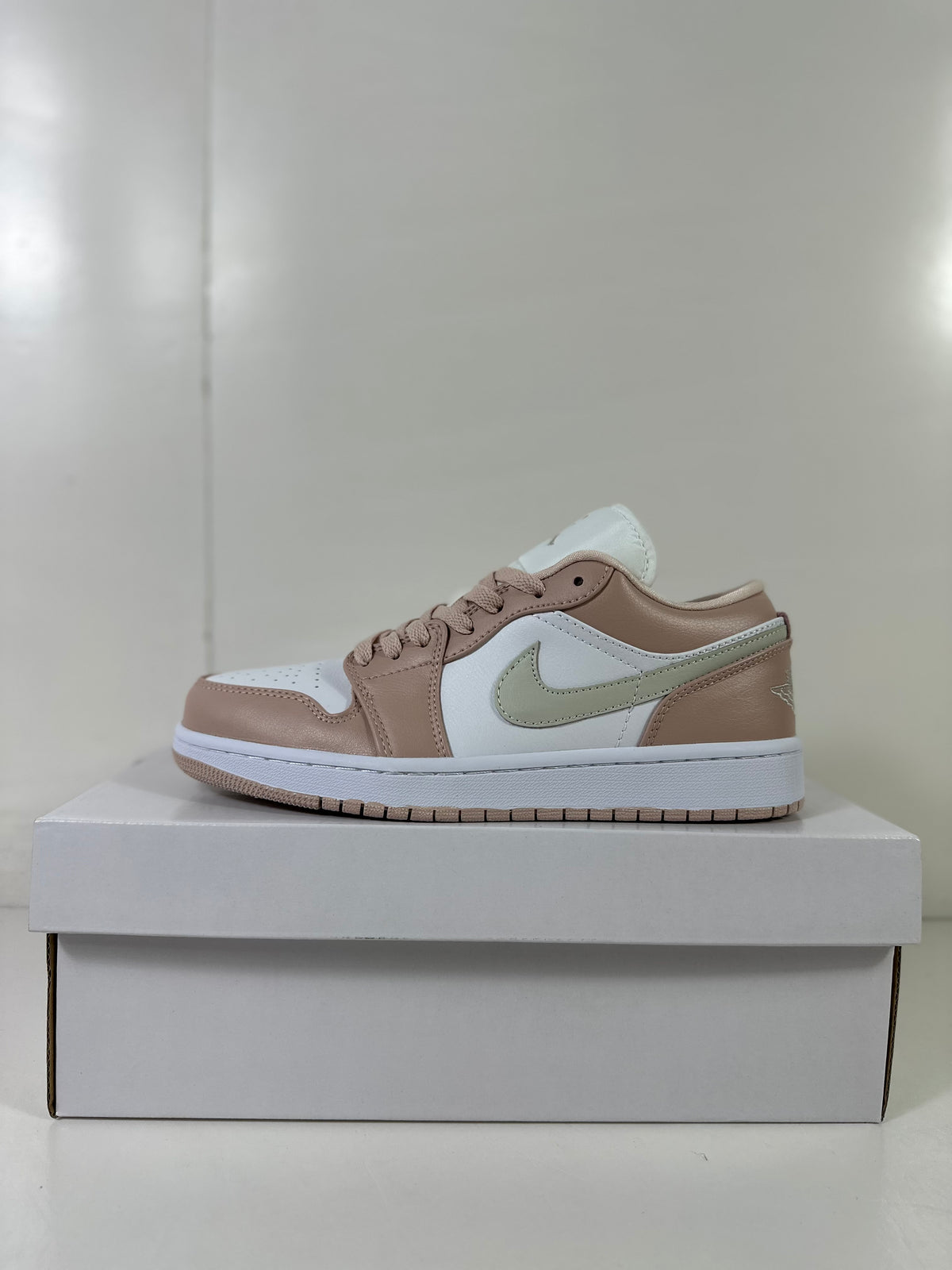 Side view highlighting the white side panel, light bone overlays, and pale green-toned Swoosh.