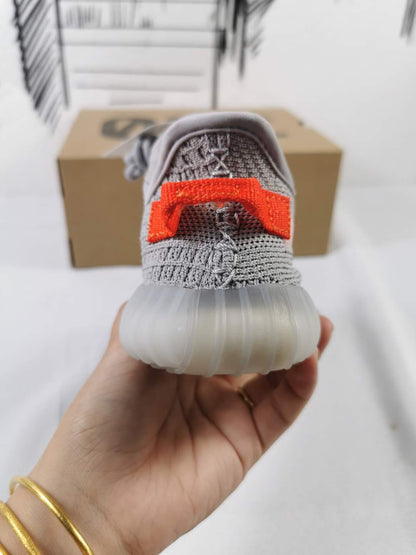 Rear view showing the orange heel pull tab and translucent outsole.
