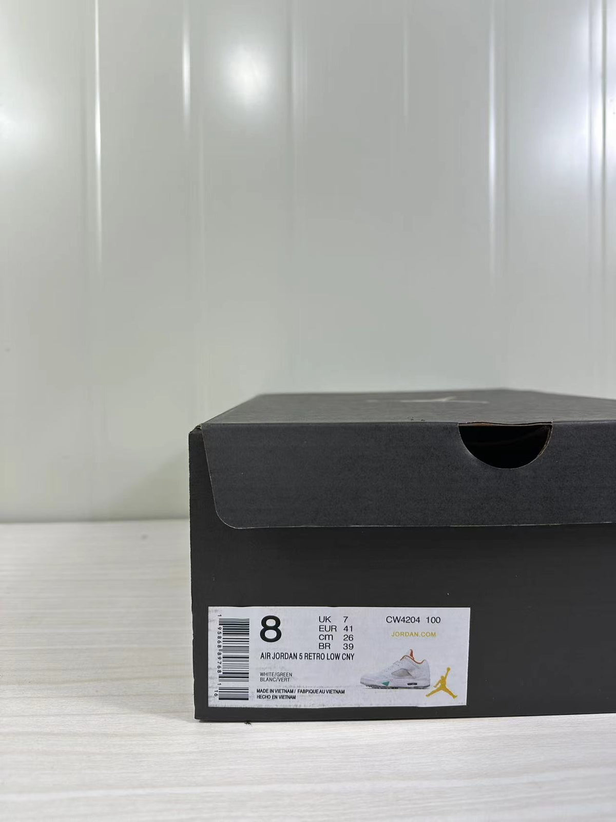 Black shoe box with a label showing Air Jordan 5 Retro Low, style code CW4204 100, EU 41, UK 7, CM 26, and BR 39.