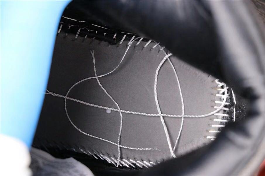 Close-up interior view showing stitching and construction details on the black upper.
