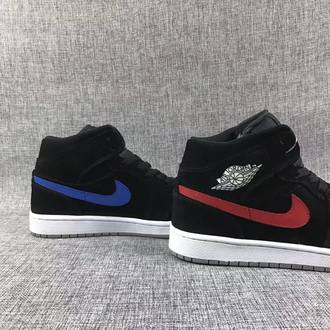 Three-quarter view of the pair with contrasting red and blue Swoosh details.