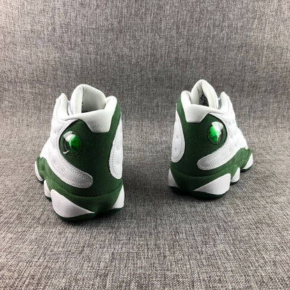Rear view of white and green Jordan high-top sneakers showing green heel panels and translucent circular details.