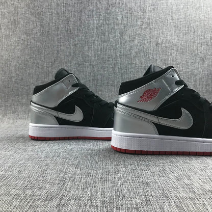 Pair of black and silver mid-top sneakers shown from the side.