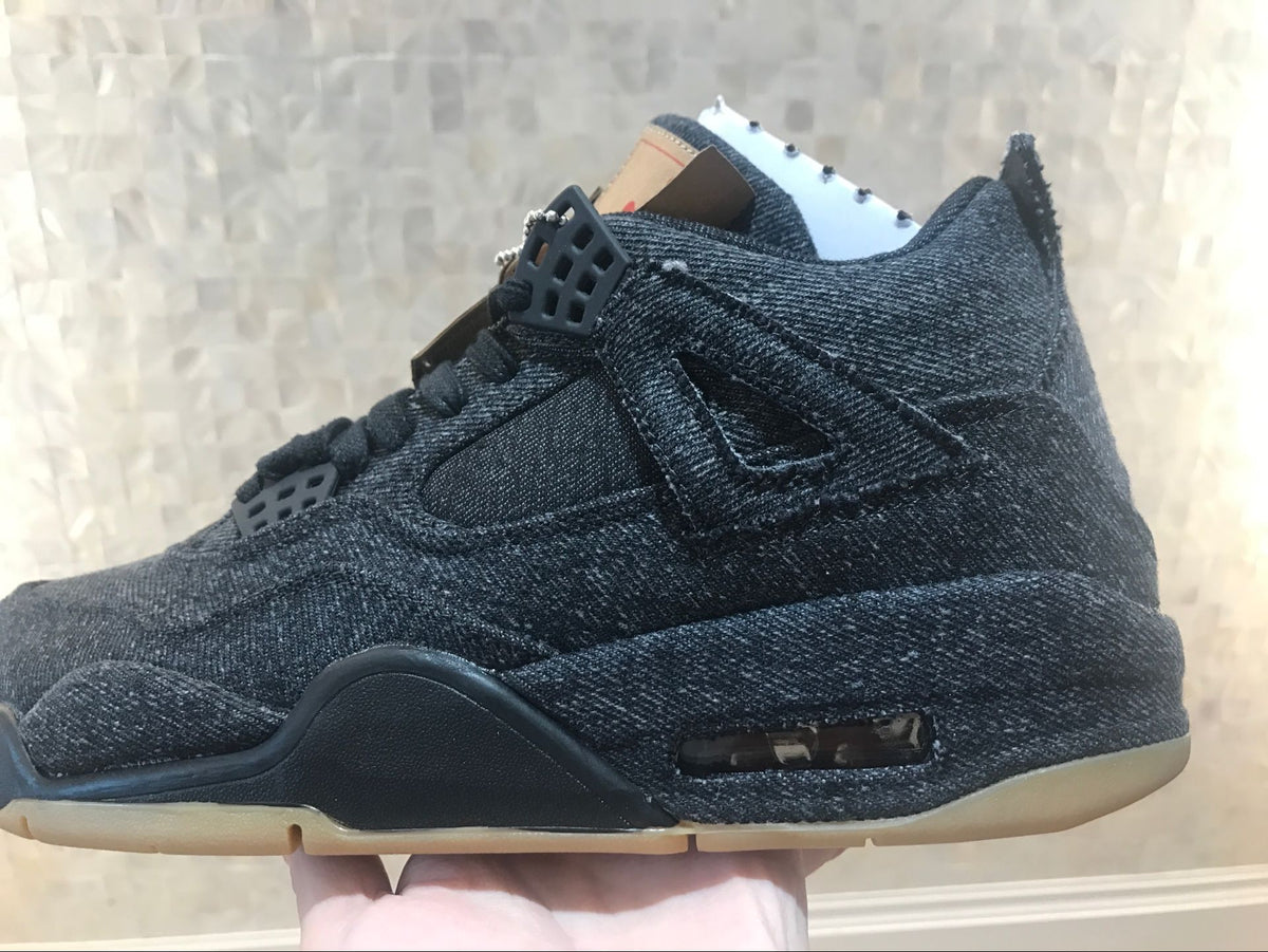 Side view showing the black high-top silhouette, layered panels and gum-colored outsole.