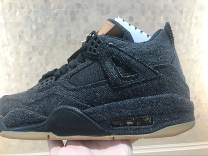Side view showing the black high-top silhouette, layered panels and gum-colored outsole.